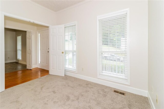 5526 Chestnut Creek Ln, Flowery Branch, GA 30542 - unfurnished room with crown molding, baseboards, carpet, and visible vents