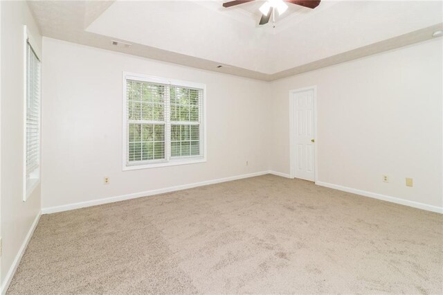 5526 Chestnut Creek Ln, Flowery Branch, GA 30542 - spare room featuring ceiling fan, visible vents, baseboards, carpet, and a tray ceiling