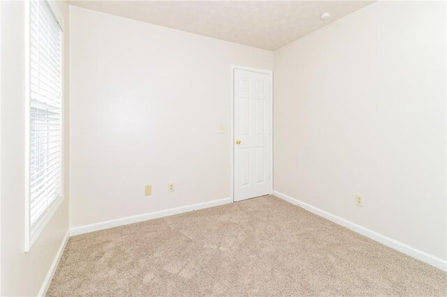 5526 Chestnut Creek Ln, Flowery Branch, GA 30542 - spare room featuring baseboards and carpet