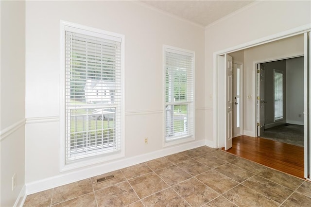 spare room featuring ornamental molding and hardwood / wood-style floors