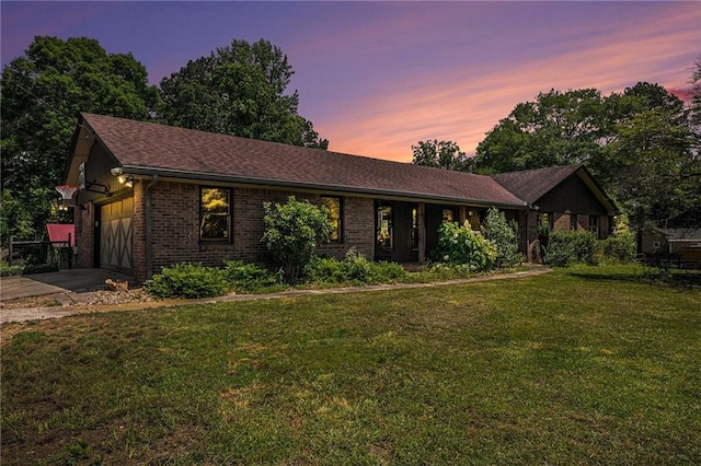 2452 Camp Mitchell Rd, Grayson, GA 30017 - ranch-style house featuring a lawn, brick siding, an attached garage, and driveway