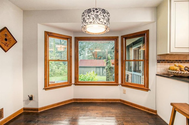 2452 Camp Mitchell Rd, Grayson, GA 30017 - unfurnished dining area with dark wood-style floors and baseboards