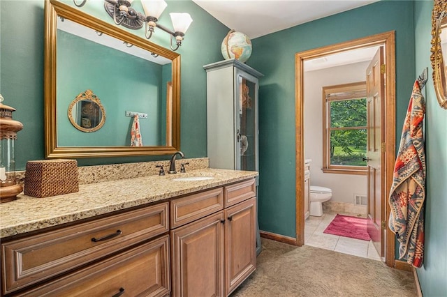 2452 Camp Mitchell Rd, Grayson, GA 30017 - bathroom featuring toilet, vanity, tile patterned floors, and baseboards