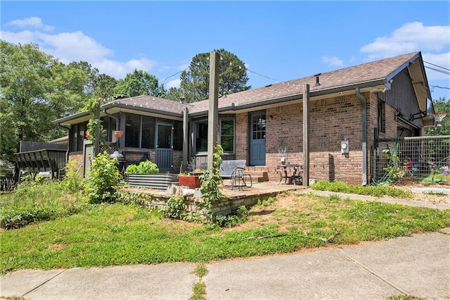 2452 Camp Mitchell Rd, Grayson, GA 30017 - back of property with a sunroom and brick siding