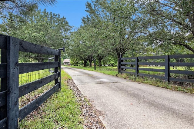 2452 Camp Mitchell Rd, Grayson, GA 30017 - view of concrete driveway featuring a gate and a gated entry