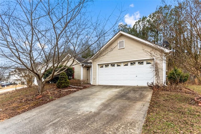 view of home's exterior featuring concrete driveway