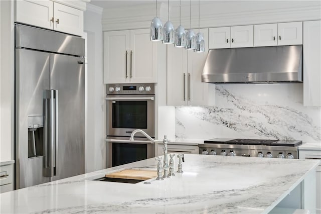 4152 Club Dr NE, Atlanta, GA 30319 - kitchen featuring white cabinets, stainless steel appliances, under cabinet range hood, and backsplash