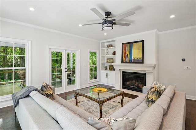 4152 Club Dr NE, Atlanta, GA 30319 - living area with ornamental molding, a glass covered fireplace, dark wood-style floors, and recessed lighting