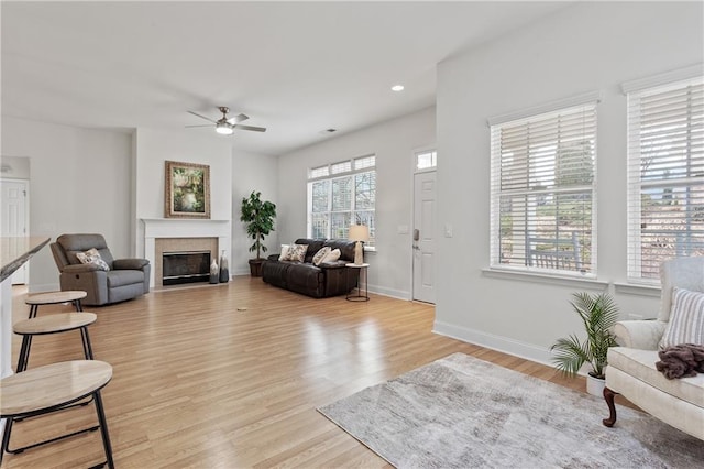 living room featuring ceiling fan and light hardwood / wood-style floors