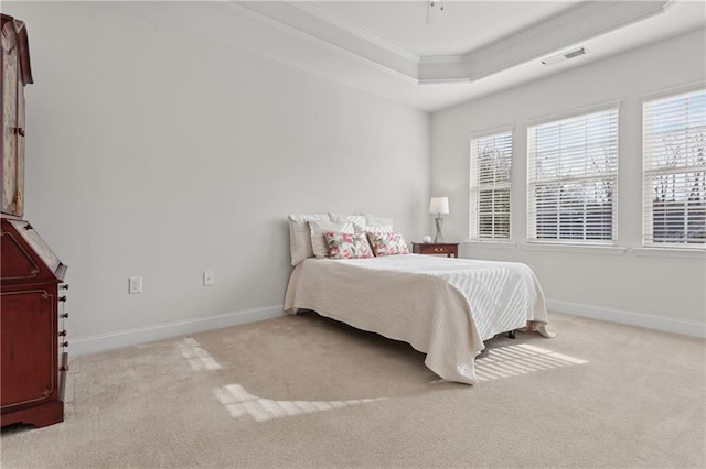 bedroom featuring a raised ceiling, light colored carpet, and crown molding