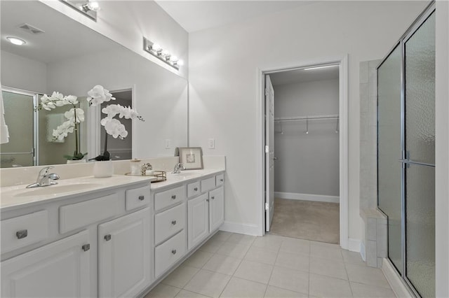 bathroom featuring vanity, tile patterned floors, and walk in shower