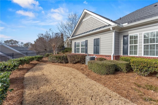 view of side of property with central AC