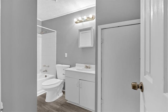 full bathroom featuring toilet,  shower combination, a textured ceiling, vanity, and hardwood / wood-style flooring