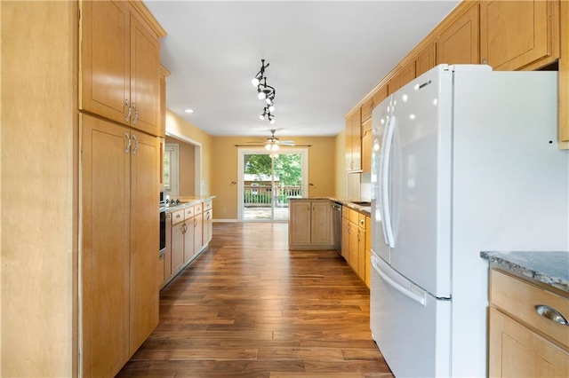 kitchen with stainless steel dishwasher, freestanding refrigerator, a peninsula, light brown cabinetry, and dark wood-type flooring