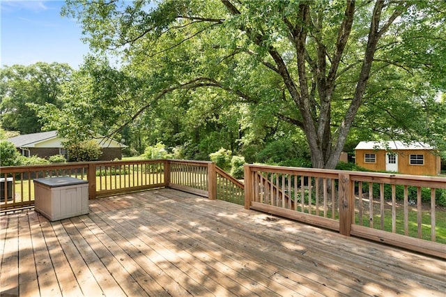 wooden terrace featuring an outdoor structure