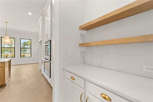 5424 Gallagher Ct, Powder Springs, GA 30127 - kitchen featuring open shelves, white cabinets, recessed lighting, light wood-style floors, and decorative light fixtures