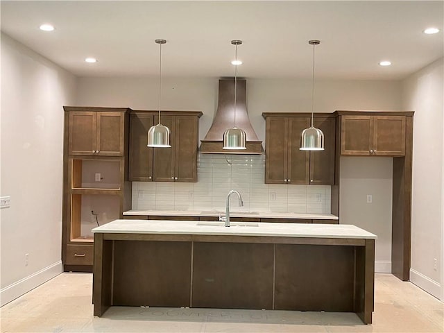 1025 Liberty Springs Dr, Woodstock, GA 30188 - kitchen with backsplash, a center island with sink, wall chimney range hood, light countertops, and recessed lighting