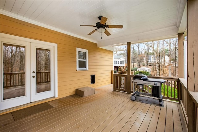 deck with a ceiling fan and french doors