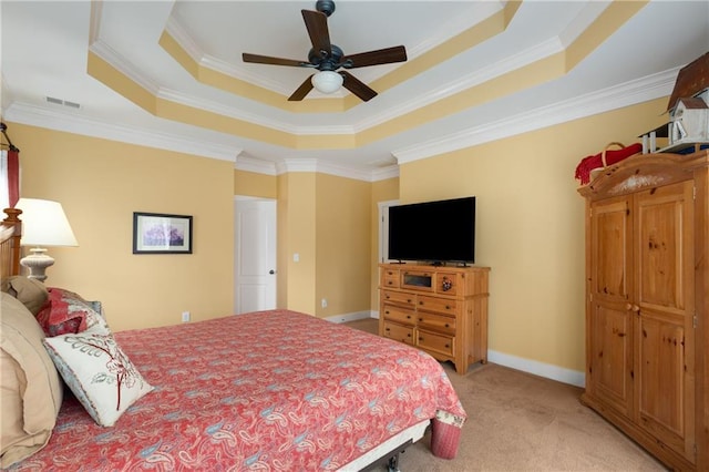 bedroom with baseboards, visible vents, a raised ceiling, light colored carpet, and ceiling fan