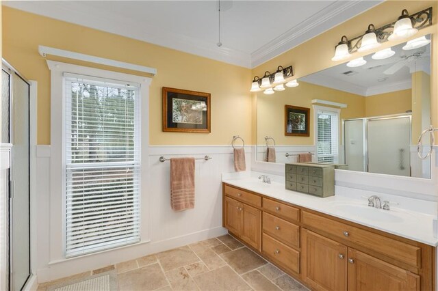 bathroom with plenty of natural light, ornamental molding, and a sink