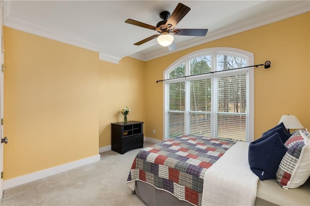 bedroom featuring light carpet, ceiling fan, baseboards, and crown molding