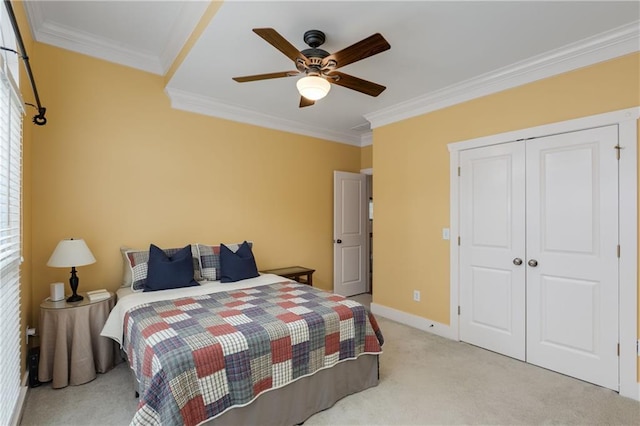 bedroom with baseboards, ornamental molding, a closet, and light colored carpet