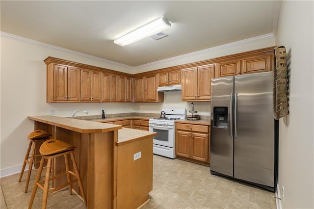 kitchen with white range with gas cooktop, visible vents, stainless steel fridge with ice dispenser, a peninsula, and light countertops