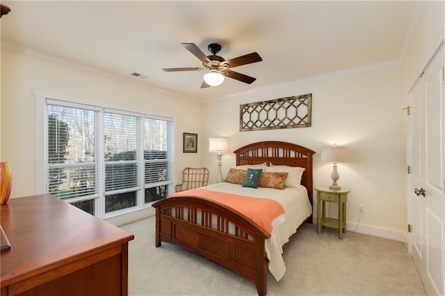 bedroom with baseboards, ornamental molding, visible vents, and light colored carpet