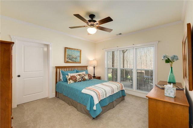 bedroom with ceiling fan, ornamental molding, visible vents, and light colored carpet