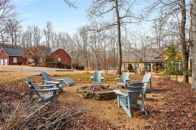 view of yard featuring an outdoor fire pit