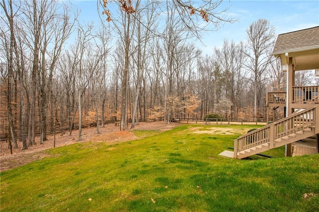 view of yard featuring stairs and a deck