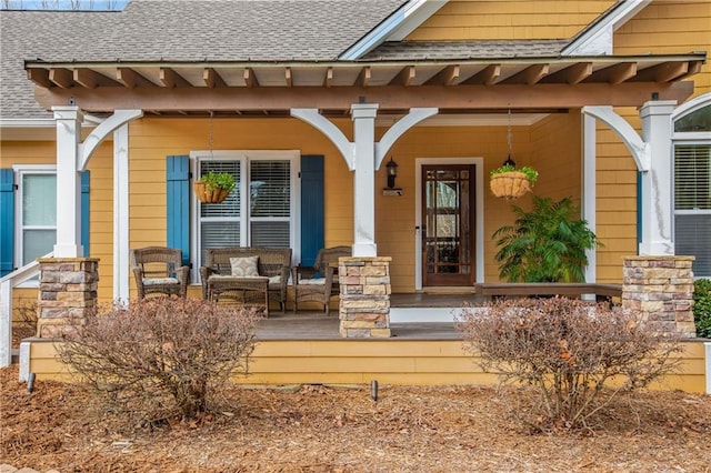 property entrance with covered porch and roof with shingles