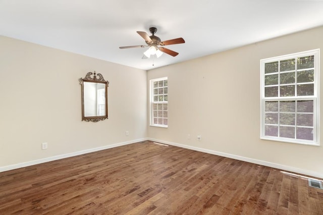 spare room featuring dark hardwood / wood-style floors and ceiling fan