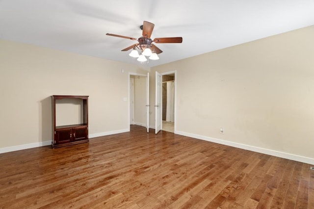 empty room featuring hardwood / wood-style floors and ceiling fan