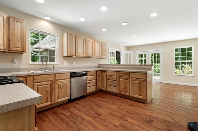 kitchen with kitchen peninsula, light brown cabinetry, stainless steel dishwasher, dark wood-type flooring, and sink