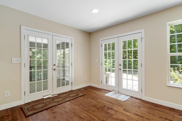 entryway with french doors and dark hardwood / wood-style flooring