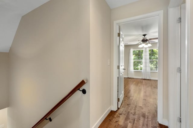 hall featuring light hardwood / wood-style flooring and vaulted ceiling