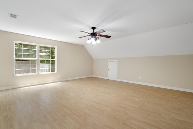 additional living space with light wood-type flooring, ceiling fan, and lofted ceiling