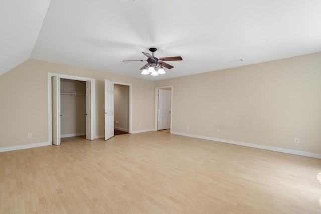 unfurnished bedroom featuring ceiling fan, light hardwood / wood-style floors, and vaulted ceiling