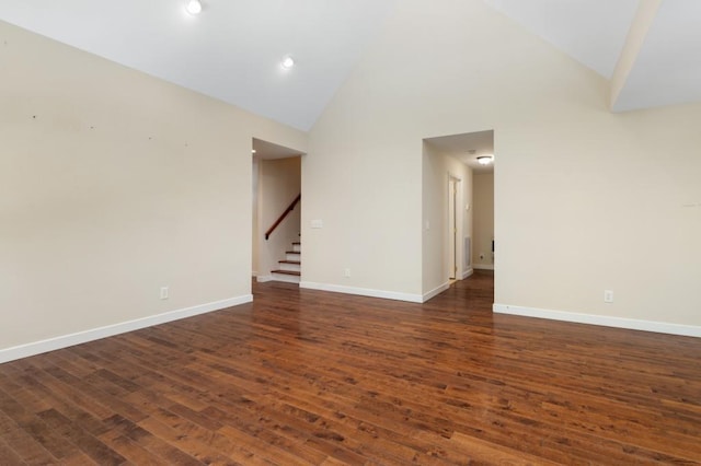 unfurnished room featuring dark hardwood / wood-style floors and high vaulted ceiling