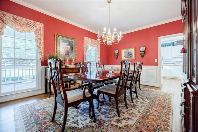 dining room featuring a notable chandelier, plenty of natural light, and crown molding