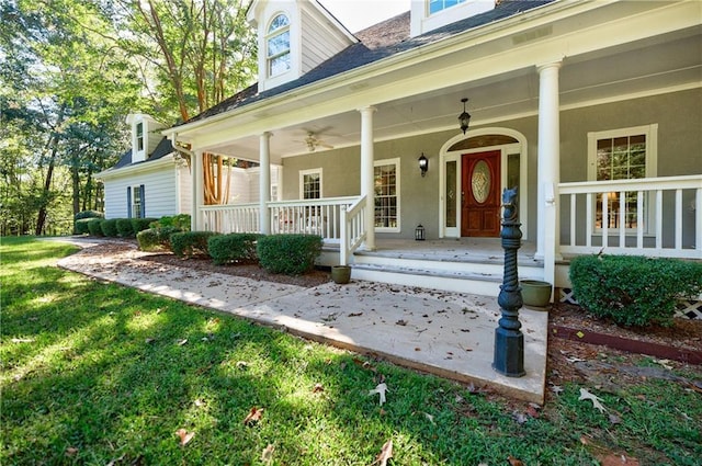 doorway to property featuring a porch and a yard