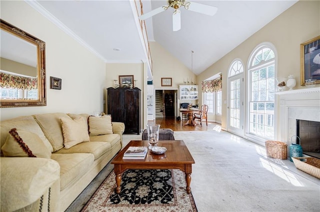 living room featuring a high end fireplace, wood-type flooring, plenty of natural light, and ceiling fan