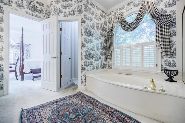 bathroom featuring crown molding and a bath