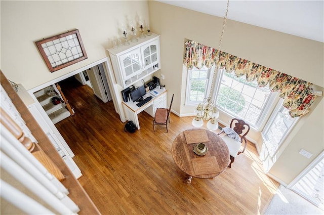 living room featuring wood-type flooring and vaulted ceiling