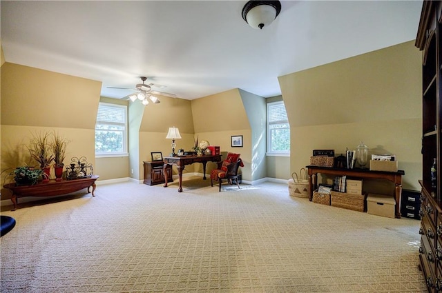 interior space featuring lofted ceiling, light colored carpet, ceiling fan, and a healthy amount of sunlight