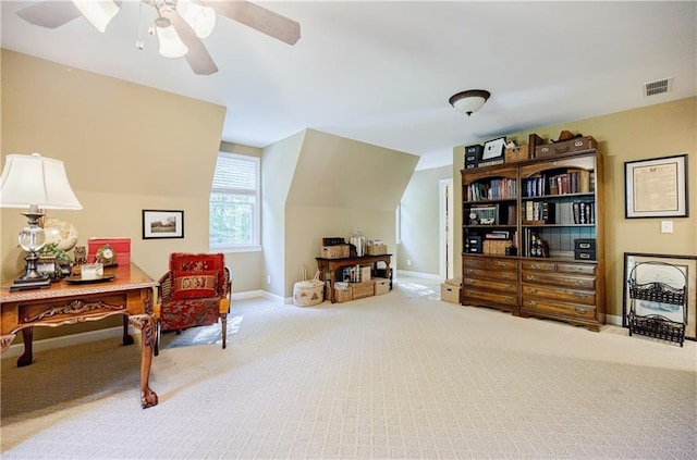 living area with ceiling fan, carpet, and lofted ceiling