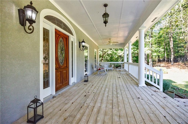 deck with ceiling fan and covered porch