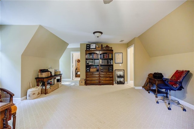 carpeted office space featuring lofted ceiling