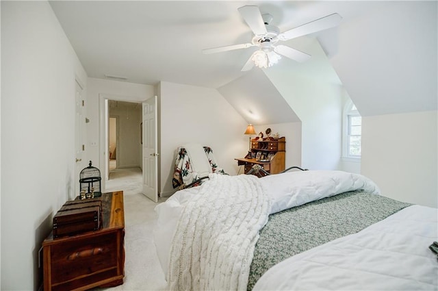 bedroom with ceiling fan, lofted ceiling, and light carpet